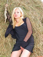 Blonde bombshell fingers herself in the hayloft of her barn.
