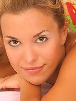 Sexy virgin Silvia poses in bed playing with her lingerie and bashfully touching her bare pubes.