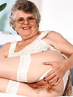 Mature model spreading her fat sagged thighs wide to expose her juicy looking hirsute cunt