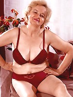 Grey haired mature model strips off to play with her sagged boobs and experienced snatch live