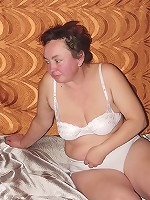 Heavyweight granny showing off in her bed