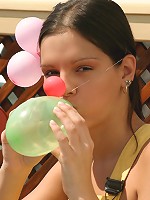 SweetEva playing with balloons in the garden