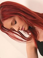 Sexy red head plays with her shaven pussy