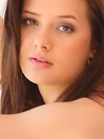 Sexy young brunette touching her pussy on the bed