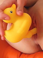 Blond and blue-eyed teen Pinky June masturbating with duck