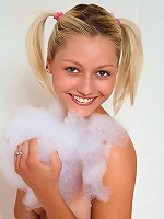 Blond and blue-eyed teen Pinky June shaves her cunt in the bath