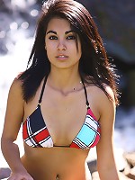 Cute teen in a bikini gets topless in the public park