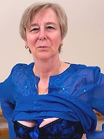 Naughty mom playing alone on her bed