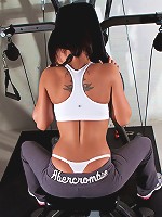 Nikki in her sports bra slexing her muscles