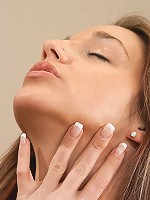 Nikki Sims covered in baby oil, rubbing her big 32DD boobs and lying down with nothing but a towel on.