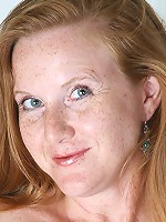 Michelle M plays maid before stripping and spreading her long legs