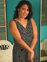 Spicy brunette Dez spreads her furry but neat pussy on the couch