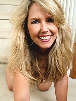 Blonde MILF Ginger B spreads her ass wide for you on the stairs