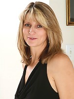 Blonde MILF Veronica B shows her pussy through fishnet stockings