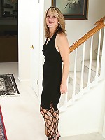 Blonde MILF Veronica B shows her pussy through fishnet stockings