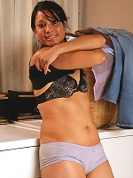 42 year old Dez strips and spreads her furry pussy in the laundry room