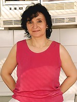 52 year old Sandra D shows off her full bush and tits in her kitchen