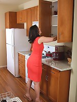 MILF with perky boobs and a nice round ass wows us from the kitchen