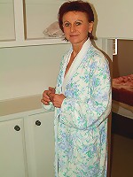 Redheaded MILF with a hairy pussy leaves her bathrobe undone