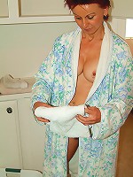 Redheaded MILF with a hairy pussy leaves her bathrobe undone