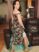 Busty and brunette Kira poses in and out of sexy tight nylons