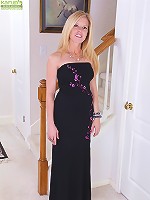 Busty mature Monique slides black dress off her tight body.