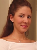 Tara posing in a braless white top