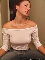 Tara posing in a braless white top