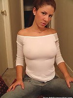 Tara posing in a braless white top