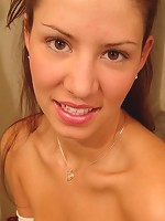 Tara posing in a braless white top