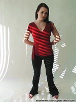 Steph poses in her red top in a studio