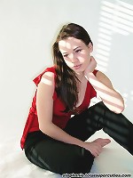 Steph poses in her red top in a studio