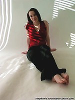 Steph poses in her red top in a studio