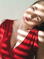 Steph poses in her red top in a studio