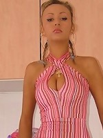 Maja strips in her kitchen