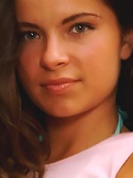 Brunette teen goes topless in a thong