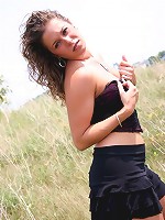 Jade outdoors in a field in a skirt on a windy day!