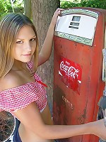 Brunette teen by the gas pump