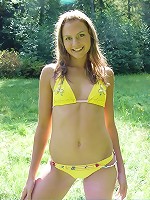 Petite brunette teen spreads her legs