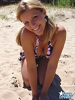 Beach teen squeezes her big boobies