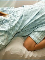 laying in bed in a baby blue shirt