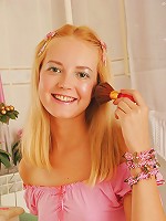 Doll-looking blond teen taking off her clothes