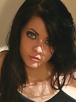 Sexy brunette babe peels off her top exposing large round breasts