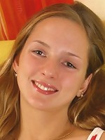 Blond girl posing topless on the couch