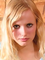 Beautiful blond girl stripping and posing nude