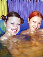 Two lesbian teens in a small pool