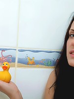 Teen brunette kissing a bath toy