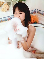 Asian girl using the shower head