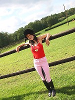 Horse riding babe inserting dildo