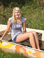Teenage blonde in a stranded boat